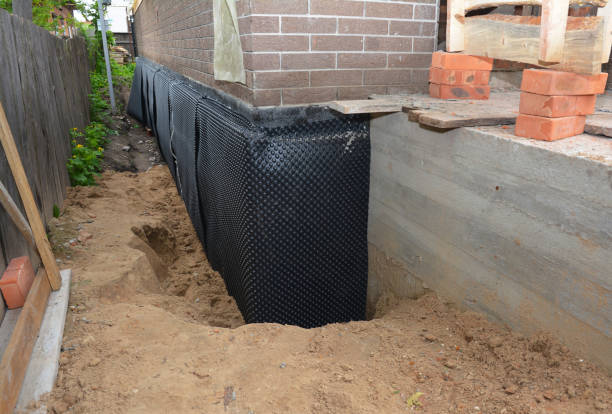 Happy homeowners after waterproofing job in Andrews